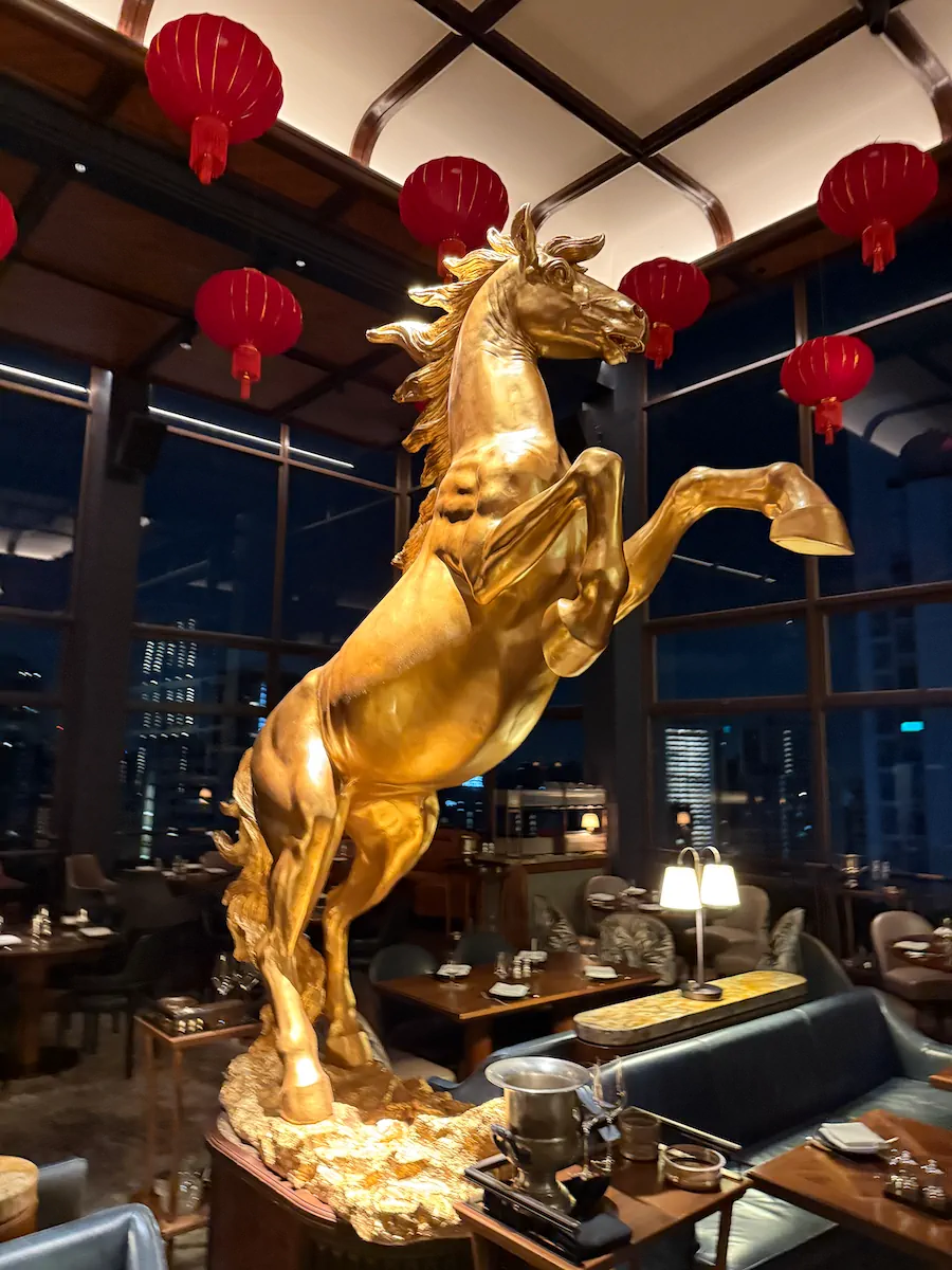 Gold horse statue red lanterns night cityscape luxury event decoration