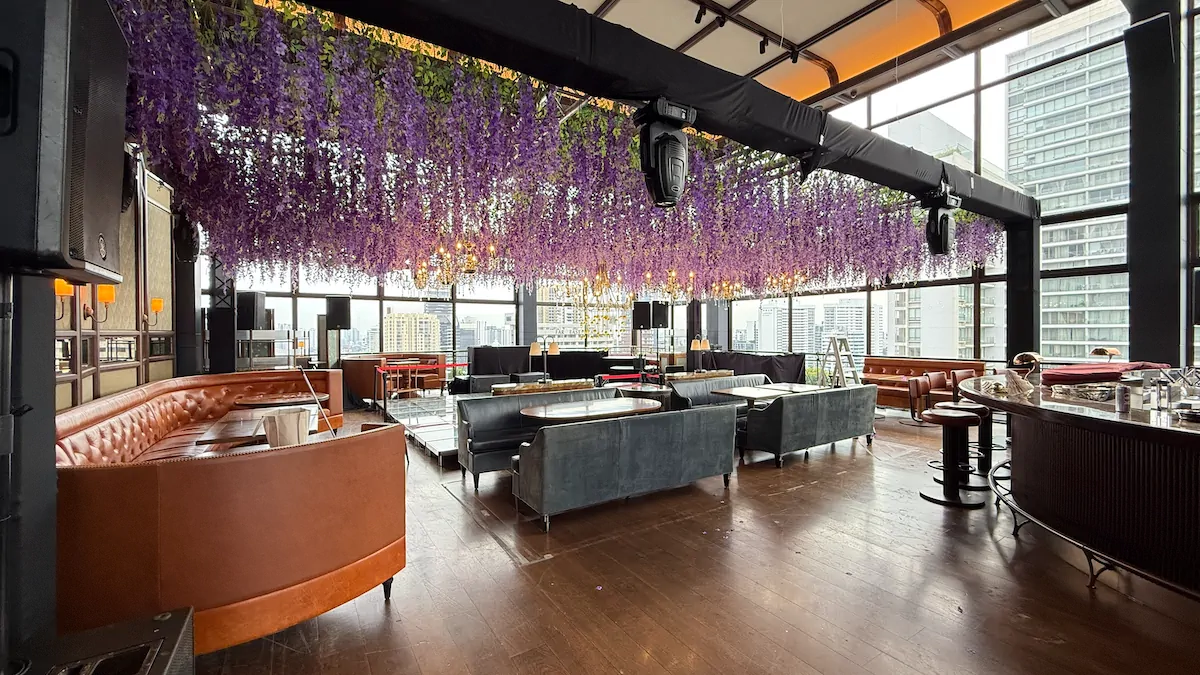 Purple wisteria floral ceiling installation corporate lounge cityscape