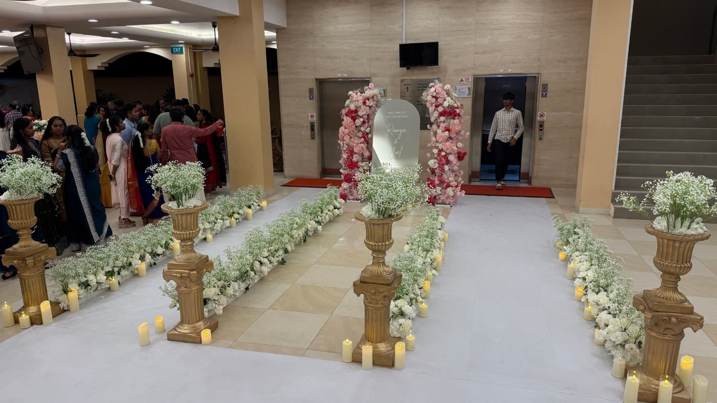 Level 1 lift lobby with gold urns, white florals and candles