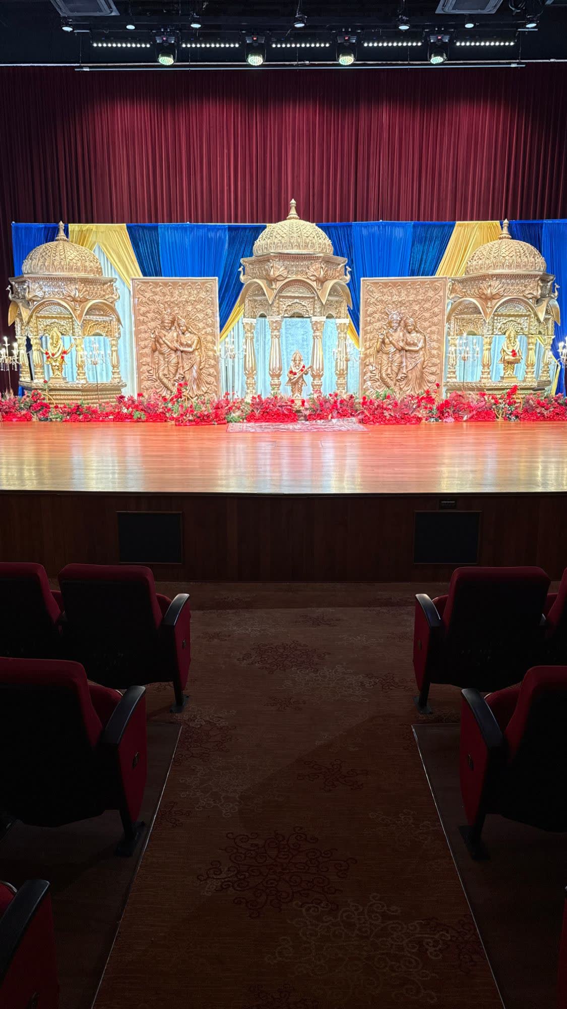 Our blue and gold stage with carved domes and Radha Krishna panels at PGP Hall