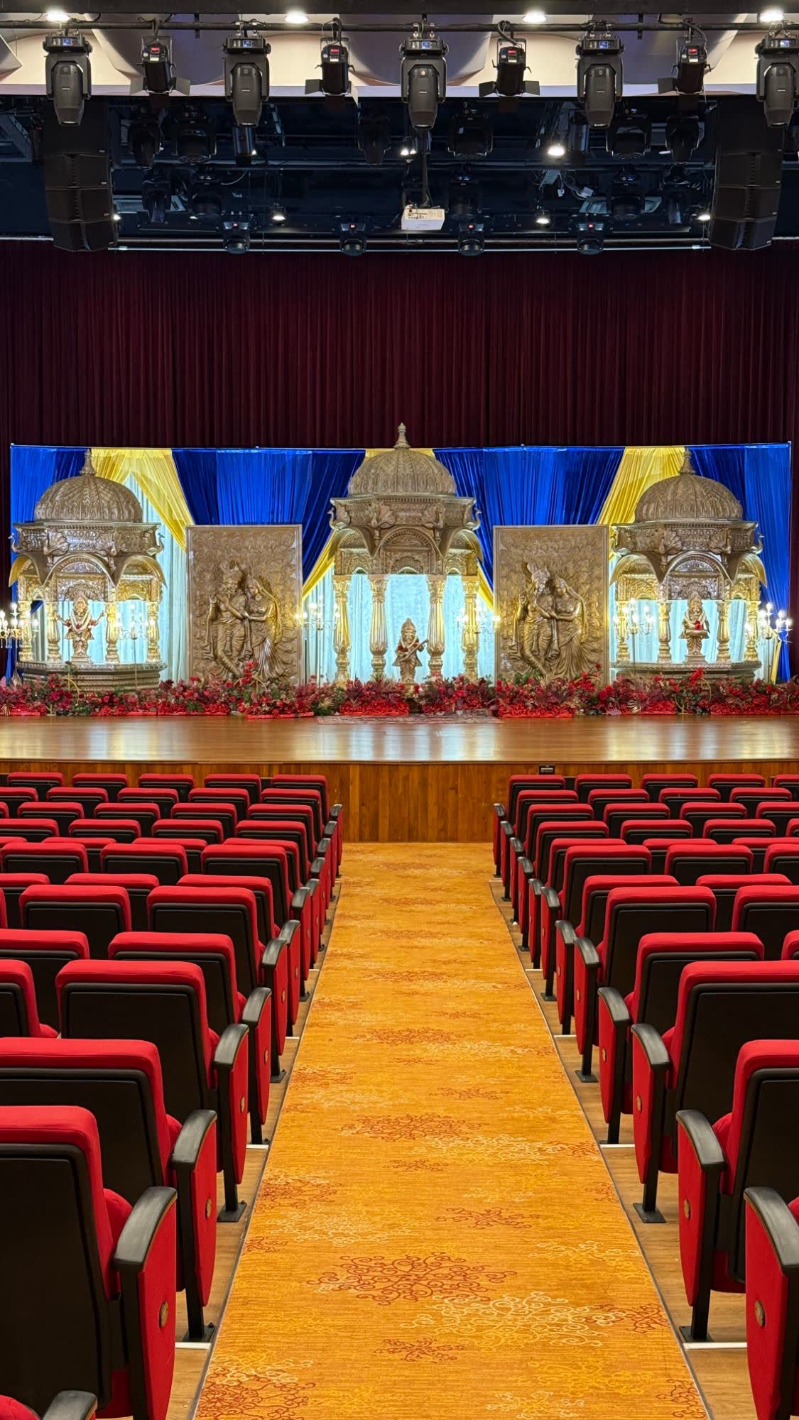 Stage close-up with red florals along the base
